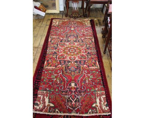 A Persian wall ground runner cut from a larger carpet, 223cm x 90cm 