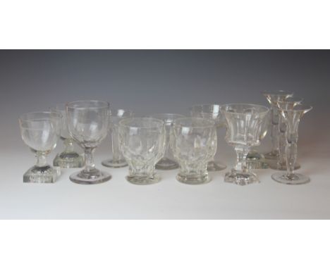 A collection of glass drinking glasses, comprising three Regency style glasses with lemon squeezer bases, two faceted glass r