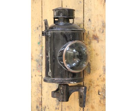 A vintage painted metal and brass Railway oil lamp, of circular form with hinged cover enclosing reservoir and burner, lid st