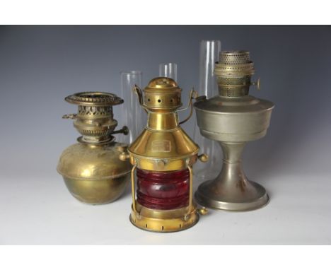 A brass and red painted glass lantern, with label for 'B Pedersen Landternefabrikk Oslo', an oil lamp, an oil lamp reservoir,