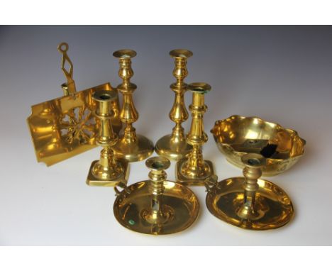 A pair of 19th century brass chamber sticks, an 18th century brass taper stick, two pairs of candlesticks, a Chinese brass ja