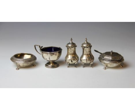 A pair of Victorian silver bun salts, Barnards, London 1875, with a matching spoon, a pair of silver pepper pots and a mustar