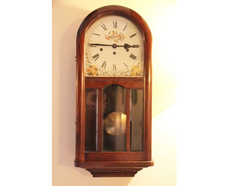An early 20th century walnut eight day wall clock, with domed top and movement striking on seven gongs, 71.5cm