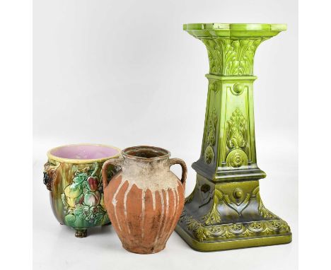 BRETBY; an art pottery green glazed jardinière on stand, with relief moulded decoration, height 89cm, a Victorian majolia jar