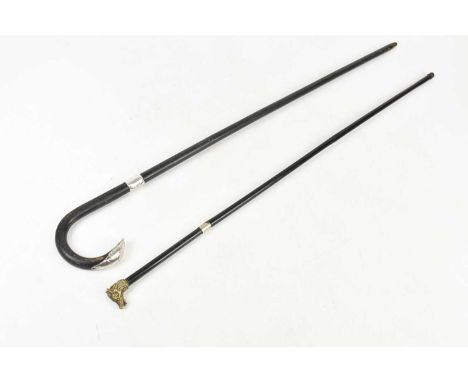 An early 20th century swordstick, the handle encasing 50cm spike, with ebonised shaft and brass boar's head finial, and an eb