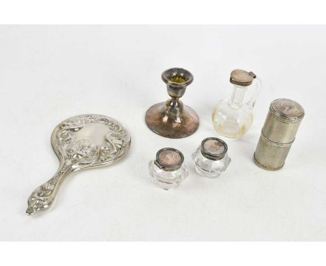 A French silver perfume bottle holder of cylindrical form, with engine turned decoration, housing four clear glass scent bott