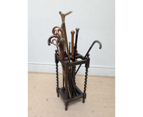 A 1920s four division stick stand, housing a collection of assorted walking sticks and canes, also an African knobkerrie, wal