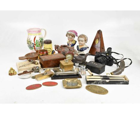 A group of collectors' items including a metronome, a camera, a sifter pepper shaker, a Tibetan scroll holder, opera glasses,