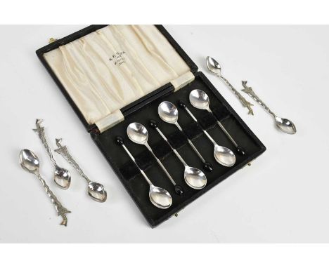 A cased set of six hallmarked silver coffee bean spoons, Birmingham 1924, and five Eastern white metal spoons, the handles fo