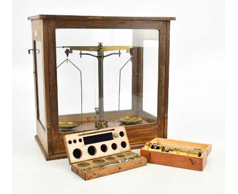 A set of early 20th century cased brass laboratory scales, with a boxed set of weights, and a brass monocular miscroscope in 