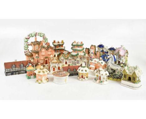 A collection of 19th century and later ceramics, predominantly pastille burners and money boxes in the form of houses/cottage