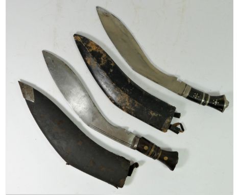 An Indian kukri, the 30cm blade pick dot decorated with two smaller knives to the scabbard and another unmarked kukri (2)This