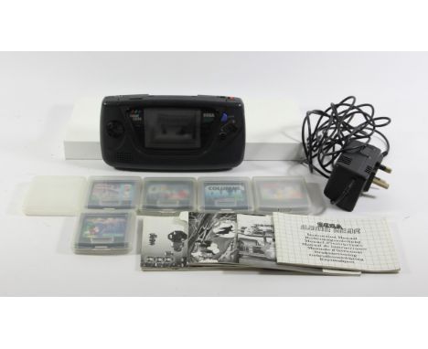 A Sega Game Gear (model No. 2110-50), manual, AC plug and 5 games, to include :Sonic The Hedgehog 2 (plastic case and manual)