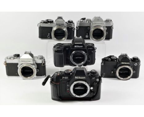 A collection of Nikon 35mm film cameras. to include a Nikon FE Chrome, a Nikon FE Black, Nikon F-501, a Nikon F-801, Nikkorma