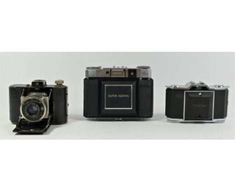 A Zeiss Ikon Super Ikonta III CRF camera, tessar lens, cased and manual, a Zeiss Ikon Contina 522/24 35mm folding camera, a K