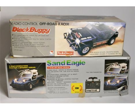 A Nikko Sand Eagle remote control buggy, original box with manual, together with a Radio Elecon black buggy radio control off