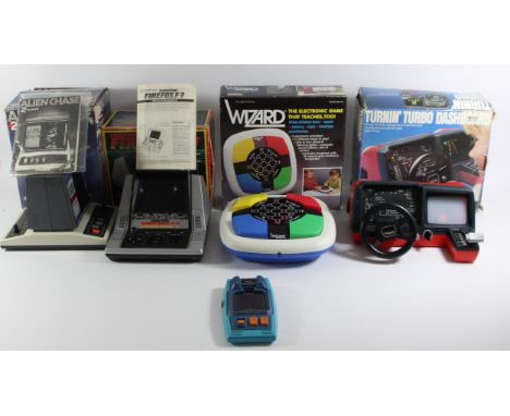 Four boxed table top battery operated games, together with a handheld, to include Firefox F-7 (original box, manual and warra