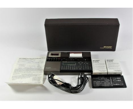 A Sharp PC-1248 Pocket Computer (serial No 77019547, a Sharp CE-125 printer and Microcassette recorder (serial No 61001112), 