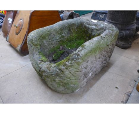 A stone D-shaped garden planter 