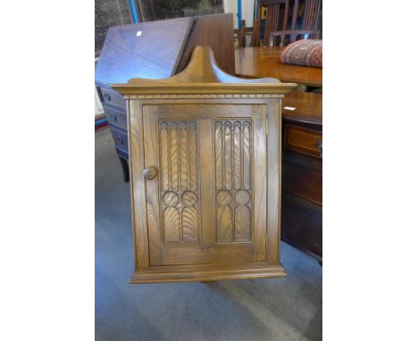 An Ercol Golden Dawn elm wall hanging corner cupboard 