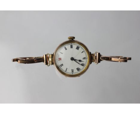 A lady's 9ct yellow gold wristwatch, early 20th century, the circular white enamel dial (cracked) with black and red Roman nu