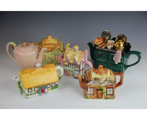 A collection of novelty teapots, to include cottage ware examples, a Police Box, a cooking range, a picnic hamper, a Walt Dis