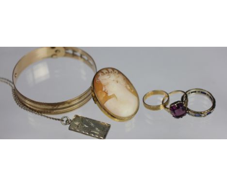 A collection of jewellery to include; a purple stone set ring in yellow gold stamped '9ct 3', a carved shell cameo brooch in 