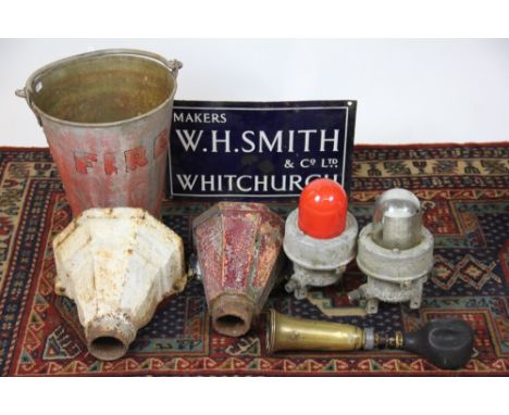 A vintage fire bucket, with a W. H. Smith of Whitchurch enamel sign, two cast iron hoppers, two waterproof lights and a horn 