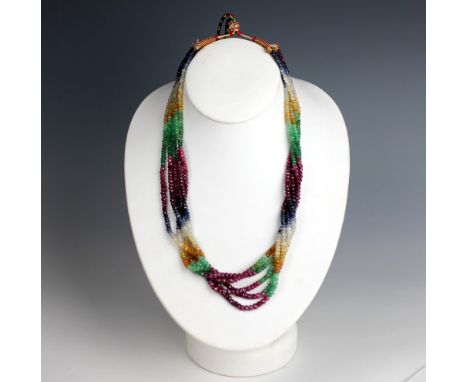 A six strand multi-gem set bead necklace, probably Indian, comprising alternating sapphire, emerald, ruby and beryl faceted b