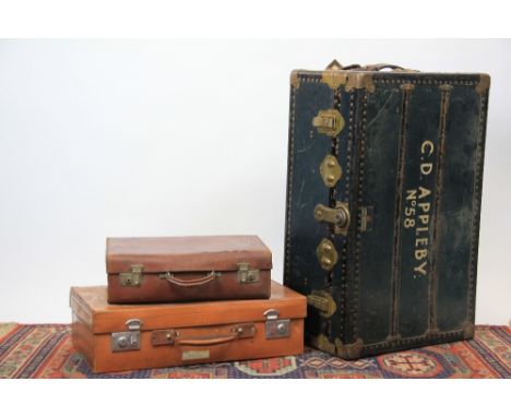 A brass bound trunk, named 'C D Appleby No. 58', 32cm H x 81cm W x 51cm D and two further leather suitcases (3)