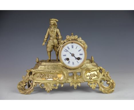 A 19th century French gilt brass eight day mantel clock, modelled with a cavalier standing beside an enamel dial, movement st