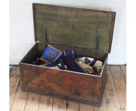 A collection of Masonic aprons and regalia, in a pine trunk