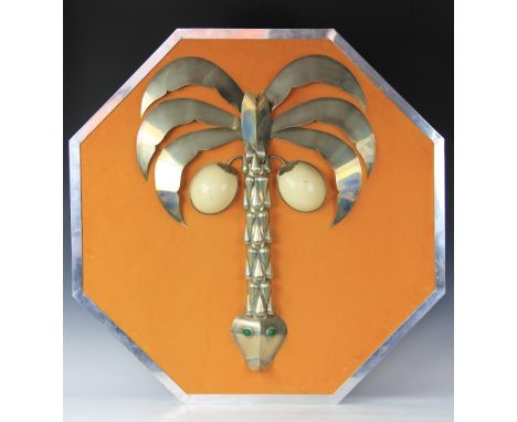 An Anthony Redmile white metal and ostrich egg octagonal wall plaque, modelled with a palm tree with serpent trunk set with m
