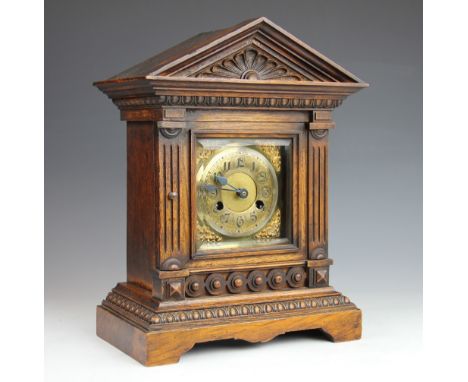 A late Victorian oak mantle clock with silvered Arabic dial and movement striking on a gong, 40cm