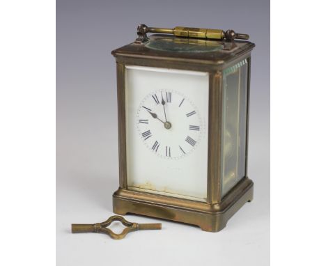 A late 19th century French brass carriage clock, enamel dial with Roman numeral chapter ring and movement striking on a gong,