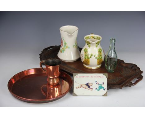 A carved oak two handled tray 61cm wide, two Atkinsons Brewery circular trays 30cm diameter, two pottery Bass water jugs, a G