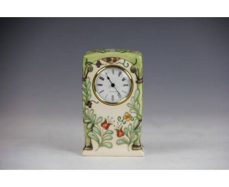 A Moorcroft mantle clock, the rectangular case decorated with flowers and trellis against a cream ground, painted '205/300', 