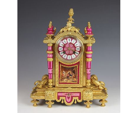 A 19th century French ormolu eight day mantel clock, set with Sevres style pink porcelain mounts, Roman numeral dial above a 