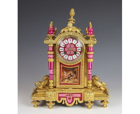 A 19th century French ormolu eight day mantel clock, set with Sevres style pink porcelain mounts, Roman numeral dial above a 