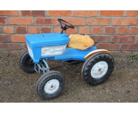 A childs Tri-ang ride-on blue tractor and yellow trailer and a Raleigh tricycle (3) 
