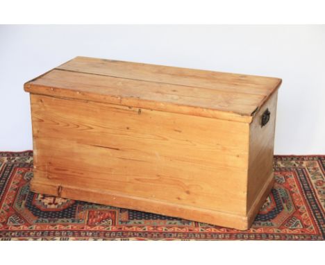 A pine trunk, with swing handles, on plinth base, 47cm H x 93cm W x 45cm D 