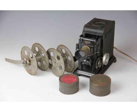 An early 20th century tin projector, initialled WS, with two cased reels of film
