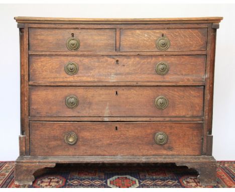 A George III oak chest, with two short over three long drawers on bracket feet, 90cm H x 108cm W x 55cm D 