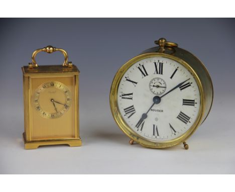 An American Ansonia brass alarm clock 'Rouser', with Roman numeral dial, 15cm diameter, with a Swiss brass carriage clock wit