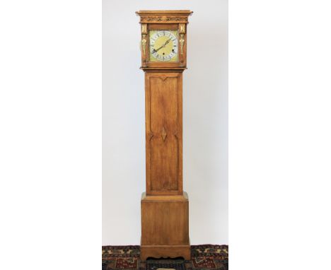A 1920's eight day golden oak grandmother clock, with silvered Roman numeral chapter ring and matted brass centre and movemen