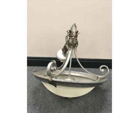 A decorative metal ceiling light with opaque glass shade 