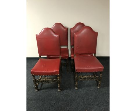 A set of four oak dining chairs in red button leather 