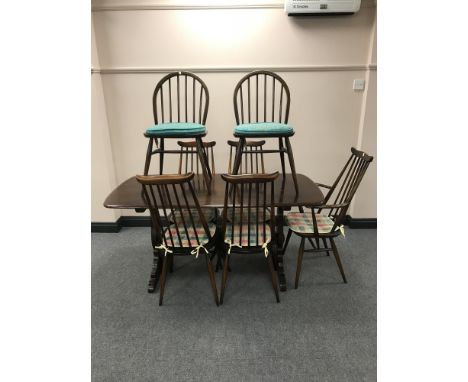 An Ercol refectory dining table together with five rail-back chairs (one carver and four singles) and a further two odd chair