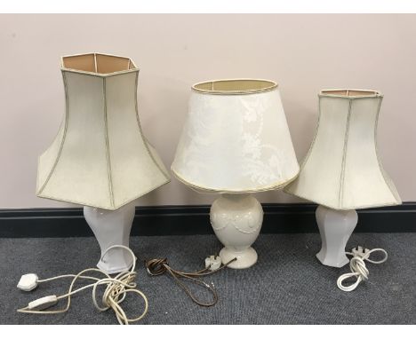 A Royal Creamware luminaries china table lamp with shade together with a pair of table lamps with shades