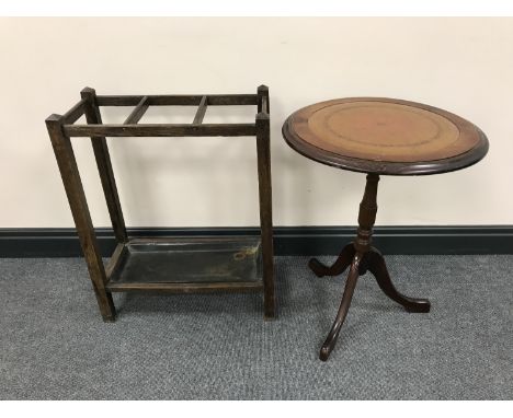 An oak stick stand with lift out tray together with a mahogany leather topped wine table